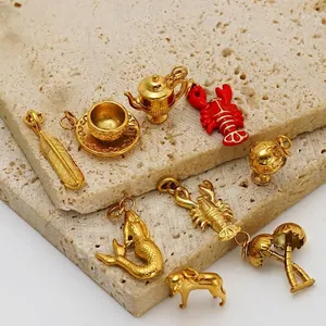 Detail view of 18K gold-plated stainless steel charms including mermaid and palm trees