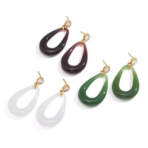 Stylish resin teardrop earrings with gold-toned titanium steel studs and clear crystals.