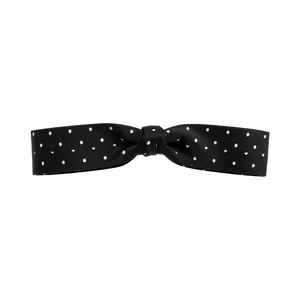 Elegant black polka dot fabric bow hair clip accessory for women in minimalist style