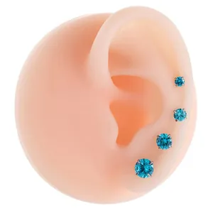 Titanium steel blue zirconia ear studs set for cartilage piercing on silicone model