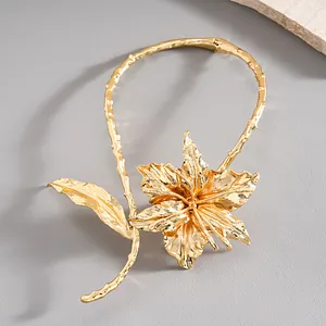 Detailed view of luxury gold crumpled metallic flower choker necklace with branch texture