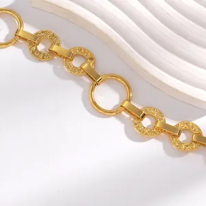 Vue macro détaillée d'une chaîne de taille dorée vintage avec des maillons circulaires texturés