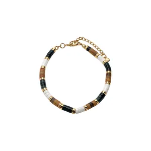 Bohemian disc beaded bracelet with gold-tone accents and extender chain on white background