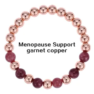 Detailed view of 6mm garnet and copper beads on menopause support bracelet