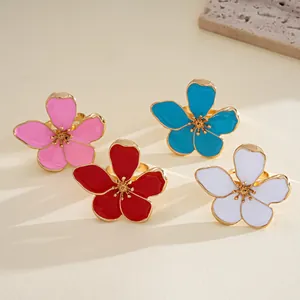 Detailed view of four colorful enamel flower rings in vibrant and fashion tones.