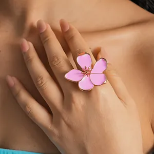 Detailed macro view of a stylish pink enamel flower ring with elegant rose gold finish