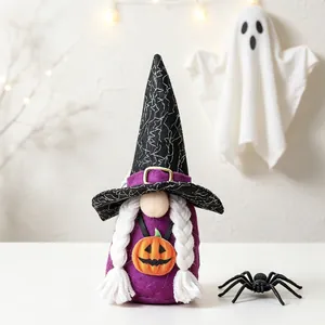 Handmade Halloween gnome with witch hat and pumpkin detail on white table