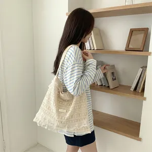 Large lace crochet tote bag for summer vacation with elegant hollowed-out details.