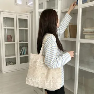 Elegant cream lace tote bag with tiered ruffles shown in a lifestyle indoor setting