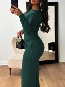 Detailed view of dark green two-piece set featuring long sleeve top and wide-leg pants