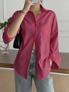 Detailed view of a fuchsia vertical striped long-sleeve button-down shirt with pocket