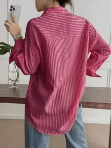 Back view detail of a pink and white striped long-sleeved casual shirt for women