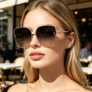 Close-up of elegant women's oversized polarized sunglasses with golden temple detail