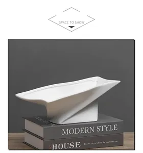 Modern white ceramic high-foot decorative tray featuring a geometric origami art design