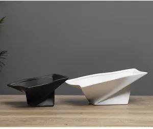 Set of two modern geometric ceramic fruit bowls in matte black and white finishes