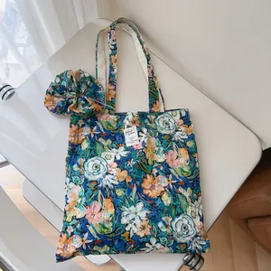 Floral print cotton tote bag and matching scrunchie with natural pleated texture for summer.