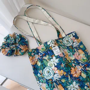 Detail view of the floral printed cotton tote bag with a matching scrunchie set