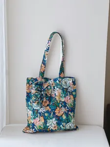 Detailed view of a floral print cotton tote bag with unique wrinkled texture
