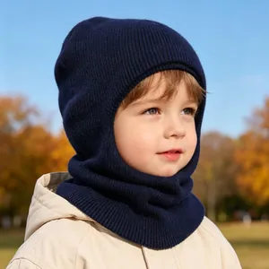 Navy blue warm knitted baby balaclava hood worn by a child in an outdoor setting