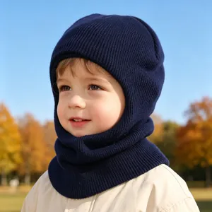 Close-up view of a child wearing a navy blue knitted winter balaclava outdoors