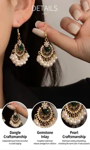 Detailed view of ethnic bohemian earrings with green gemstone and pearl tassels