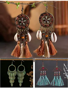 Detailed view of bohemian tribal earrings with tassels, shells and geometric charms