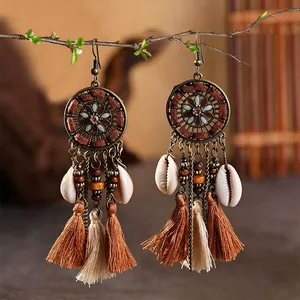 Handmade bohemian tribal style long tassel earrings with cowrie shell and bead accents
