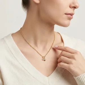 Elegant 925 silver golden necklace with heart pendant and toggle clasp on female model
