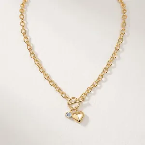 Elegant gold heart pendant necklace with crystal charm and stylish toggle clasp