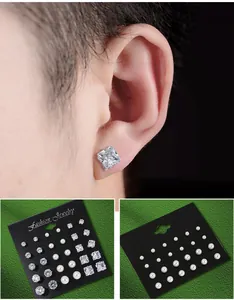 Detailed view of 12 pairs zircon and pearl stud earrings set on black display cards