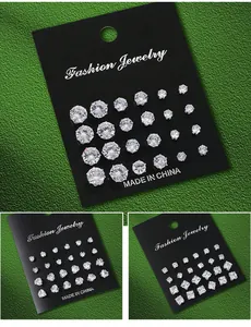 Detailed view of cubic zirconia stud earring sets in various shapes on black display cards