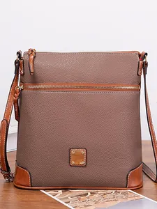 Elegant vintage pebble textured crossbody bag with tan leather trim and gold zipper
