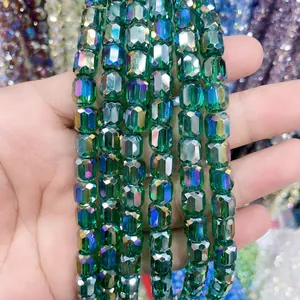 Detailed view of 8x9mm faceted green glass crystal cylinder beads for DIY jewelry.