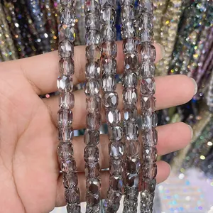 Macro detail of 8x9mm faceted cylindrical smoke grey glass crystal beads for DIY