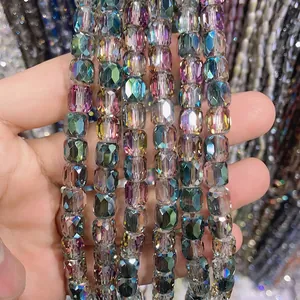 Close-up of 8x9mm iridescent cylindrical faceted crystal glass beads for DIY jewelry.