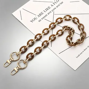 Stylish brown acrylic and gold metal link bag strap with lobster clasps