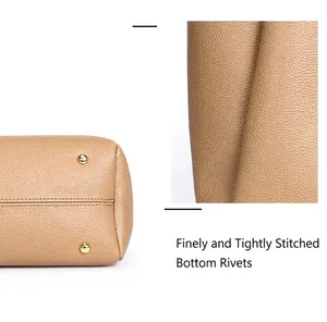 Gros plan sur les rivets du fond et les coutures d'un sac cabas couleur kaki.