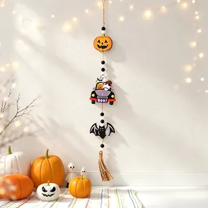 Detail of a Halloween wooden beaded garland featuring pumpkin and bat charms for party decor