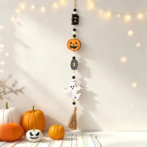 Detail of Halloween wood bead garland with pumpkin and ghost charms hanging on wall