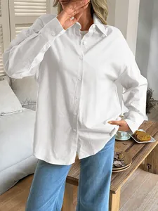 Elegant white long-sleeved button-down shirt for women with soft linen fabric texture