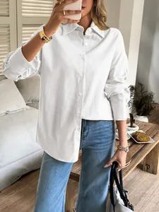 Elegant close-up view of a white long sleeve casual button-down shirt for women in a lifestyle setting