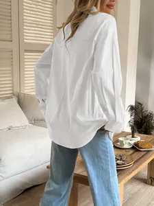 Back view of a casual white long-sleeved shirt for women shown in a cozy home setting