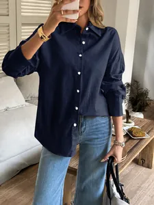 Detailed view of a woman wearing a casual navy blue long-sleeved button-down shirt