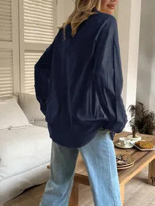 Back view showing the fabric and cut of a navy blue long-sleeved casual shirt