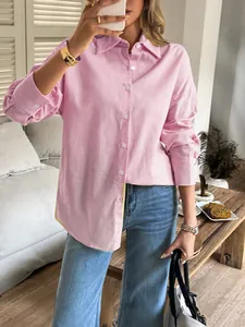 Detail view of a pink long-sleeved textured shirt with a classic button-down design.