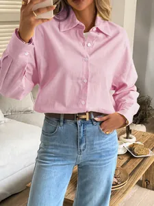 Close-up detail of a casual pink long-sleeve button-down shirt for women in a stylish look