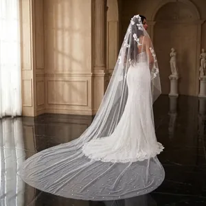 Detail showing the 3m cathedral wedding veil with floral lace and pearl beads.
