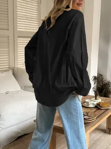 Casual solid black long-sleeved women's shirt with a relaxed fit, ideal for vacation.