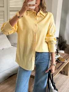 Close-up detail of a stylish pale yellow solid color long sleeve shirt for casual resort wear