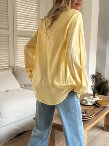 Detailed back view of a casual yellow long-sleeved shirt with breathable textured fabric